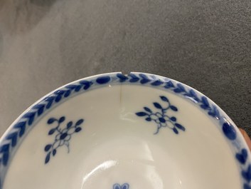 A pair of Chinese blue and white 'Caritas' cups and saucers, Kangxi/Yongzheng